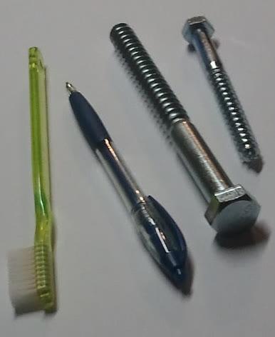 Four hex-head lag bolts and a washer on a white background.