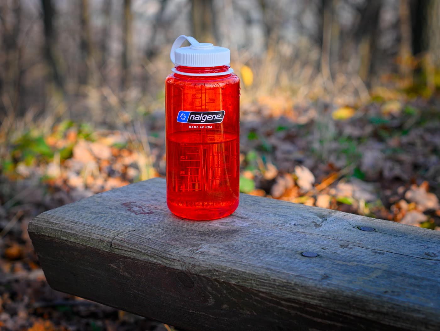 A wide-mouth Nalgene bottle with volume marks, lying on its side.
