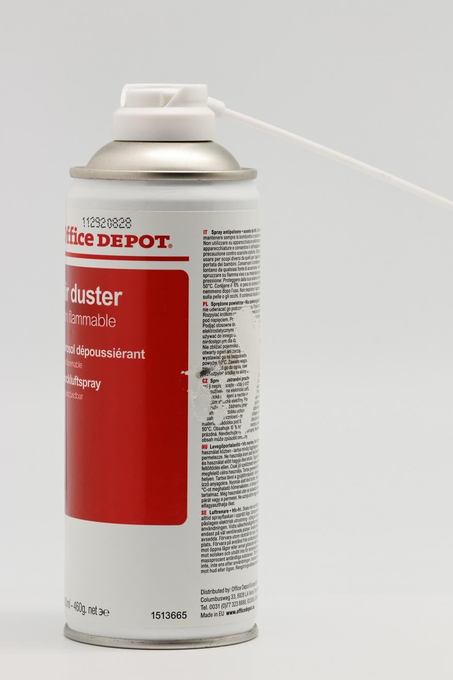 A can of compressed air with a thin straw, aimed at a keyboard.